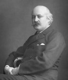 A B&W photo of a man from the 1890s looking to camera