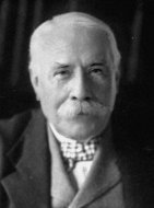 A b&w photo of man looking to camera