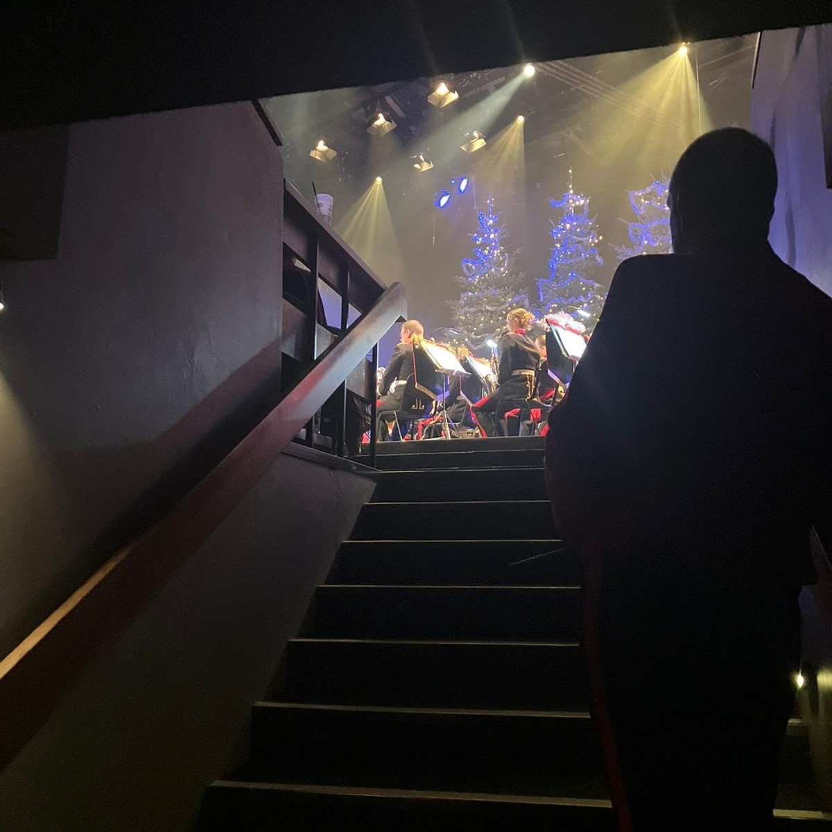 A Lay Vicar waits in the side of the stage watching another performer