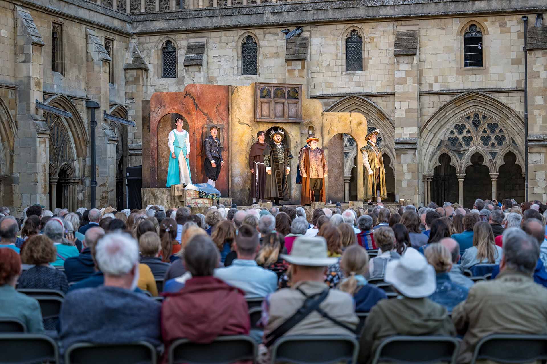 The Lord Chamberlain's Men perform on stage with a large crowd