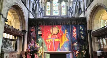 A vibrant modern tapestry in a cathedral setting