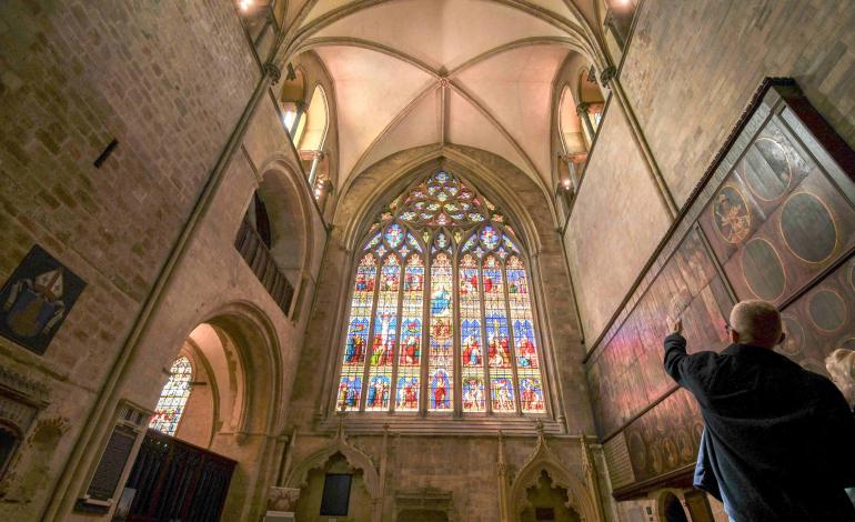 People pointing at cathedral ceiling