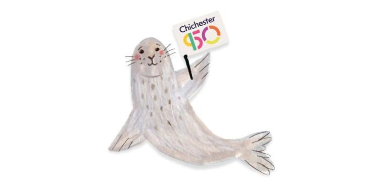 Wilfrid the Seal holding a Chichester950 Flag