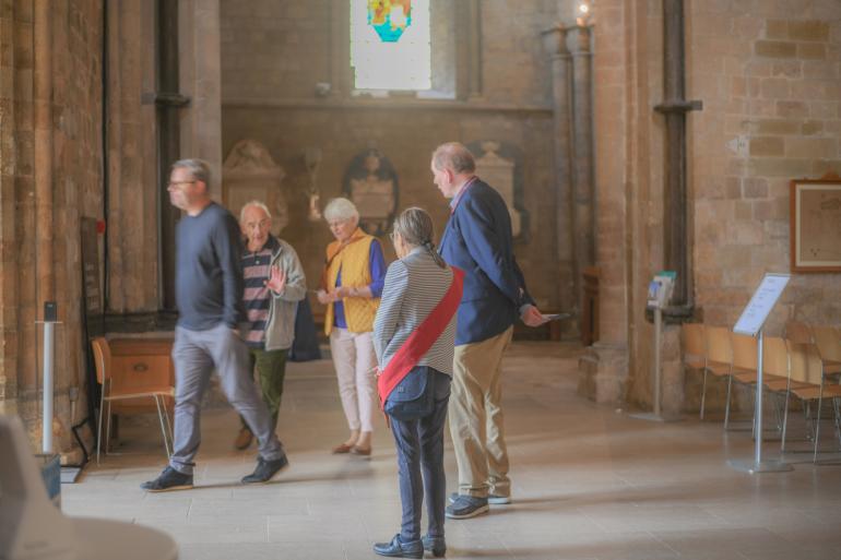 Volunteers say goodbye to visitors leaving the Cathedral