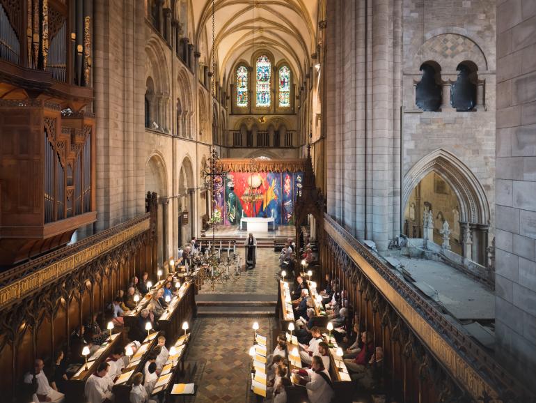 photo by Ash Mills of inside the Cathedral with candles lit