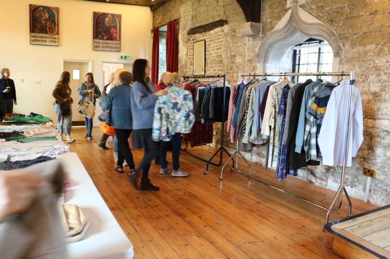 People looking through clothes during our Clothing Swap Shop Event